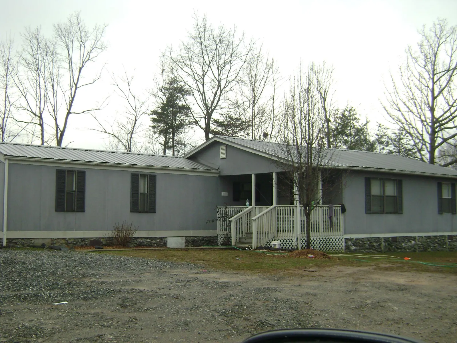 Metal roof over a manufactured home with a covered front porch in Greenville